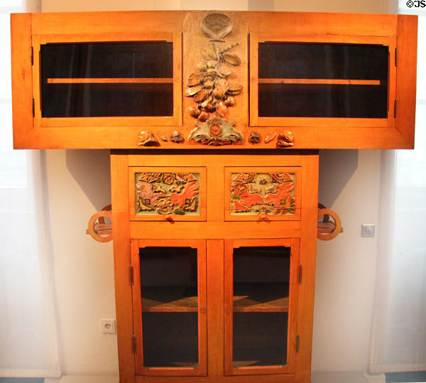 Wooden cabinet with glass doors & carved decorations (1881) by Paul Gauguin (Paris) at Hamburg Decorative Arts Museum. Hamburg, Germany.