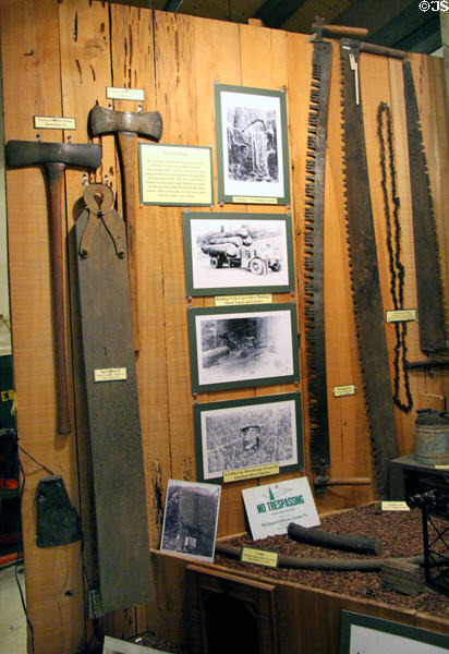 Display of photos, tools & equipment used in harvesting of trees, manufacturing of logs & transport to market at El Dorado County Historical Museum. Placerville, CA.