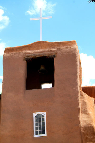 Adobe tower with cross of San Miguel Mission. Santa Fe, NM.