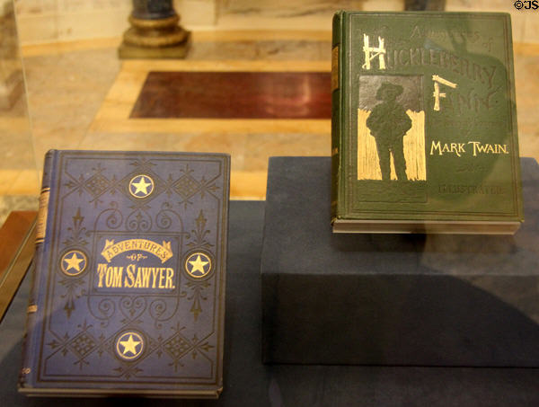 Early copies of Adventures of Tom Sawyer and Huckleberry Finn by Mark Twain on display at Morgan Library. New York City, NY.