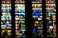 South transept stained glass windows of St Stephen's Cathedral with people & monkeys. Sens, France.
