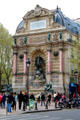 St-Michel Fountain affixed to end wall of building as part of vista plan by Baron Haussmann. Paris, France.
