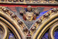 Painted angel holding royal crowns at St Chapelle. Paris, France.