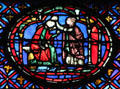 Seated man with woman stained glass scene at St Chapelle. Paris, France.