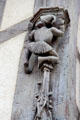 Carving detail of man in Medieval dress climbing pillar on Acrobats house. Blois, France.