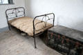 Iron frame bed & clothing trunk in Matron's quarters at Irish Workhouse Centre. Portumna, Ireland.