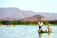 Fishermen in a canoe on Lagoon Coyuca. Mexico.