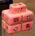 Porcelain tea caddy mimics tied bale which Chinese characters by Christopher Dresser made by Minton & Co of Stoke-on-Trent at Ashmolean Museum. Oxford, England.