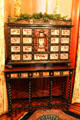 Cabinet with inlaid drawers on table with stretchers at Kimberly Crest House. Redlands, CA.