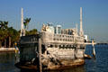 Bow of Stone boat of Vizcaya mansion with condos along shoreline. Miami, FL.