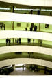 Guggenheim Museum spiral ramp interior seen from above displays modern art on a continuous surface. New York, NY