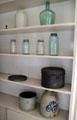 Kitchen shelving with glass canning jars, stoneware crocks & other vessels at Lindenwald. Kinderhook, NY.
