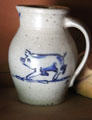 Ceramic pitcher with painted pig in Ritch Hat Shop at Old Bethpage Village. Old Bethpage, NY.