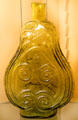 Yellow-green blown glass scroll flask attr: Crosby &. Shepard, Zanesville at Stone Academy Museum. Zanesville, OH.