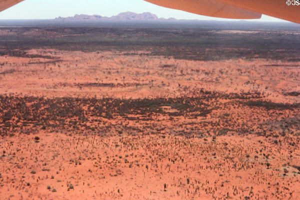 The Olgas near Uluru (aka Ayers Rock) & red earth surrounding them, seen from air. Australia.