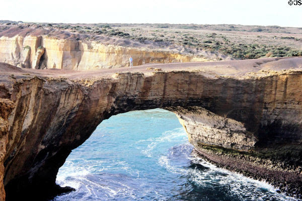 Natural rock arch carved by sea along shore of Victoria in Port Campbell National Park. Australia.