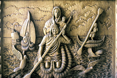 Detail of Cathedral door carving of natives & virgin in reed boats, Copacabana. Bolivia.