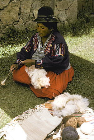 Woman spinning Alpaca thread on Sun Island. Bolivia.