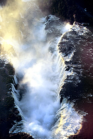 Mist rises up from Iguaçu's devil's throat U-shaped falls. Brazil.