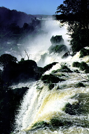 Water cascades over the rocks of Iguaçu Falls. Brazil.