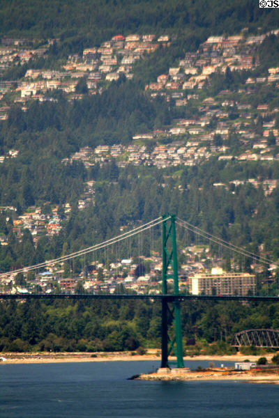 Lions Gate Bridge against housing of North Shore. Vancouver, BC.