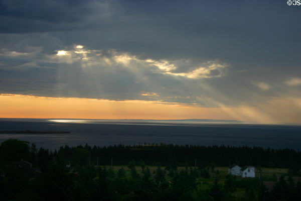 Light streams through clouds over Bay of Fundy. NB.