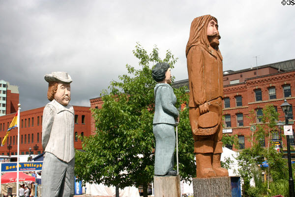 Wood carvings of Acadian heroes (2001-3) by Albert Deveau on Market Square. Saint John, NB.