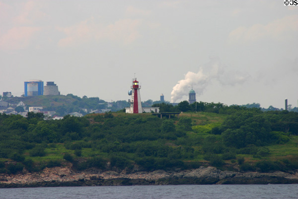 Lighthouse at entrance to Saint John Harbor with city beyond. Saint John, NB.