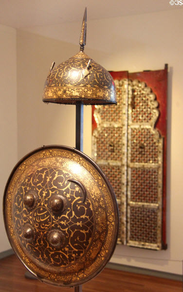 Forged steel overlaid with gold Rondache & helmet (first half 19thC) from Iran at Aga Khan Museum. Toronto, ON.