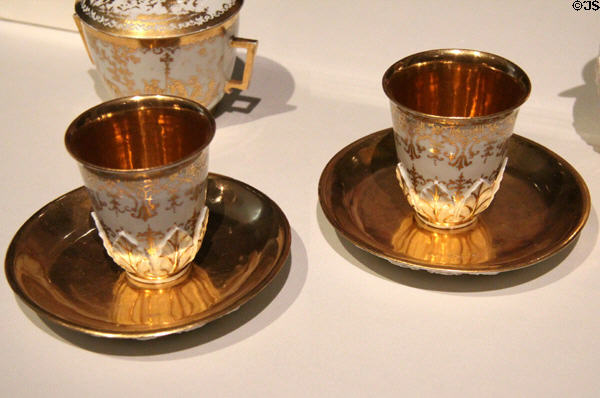 Meissen porcelain beakers & saucer decorated with gold leaf (c1720) attrib. Johann Georg Funcke at Gardiner Museum. Toronto, ON.