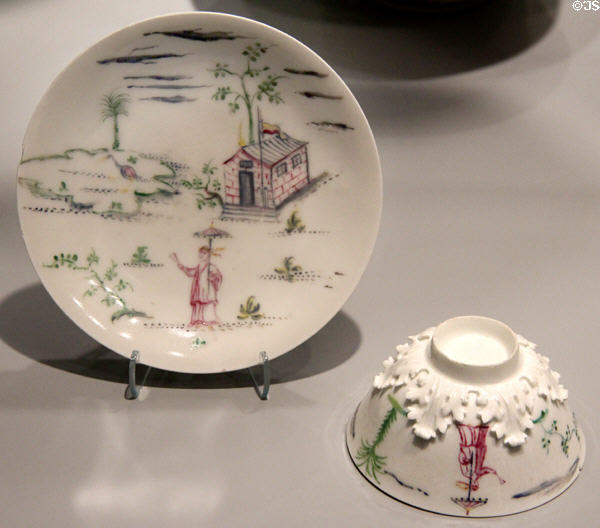 Meissen porcelain tea bowl & saucer with overglaze Chinese scene & applied leaves (c1713-17) by Johann Jacob Irminger & decorated by workshop of George Funcke in private collection. ON.