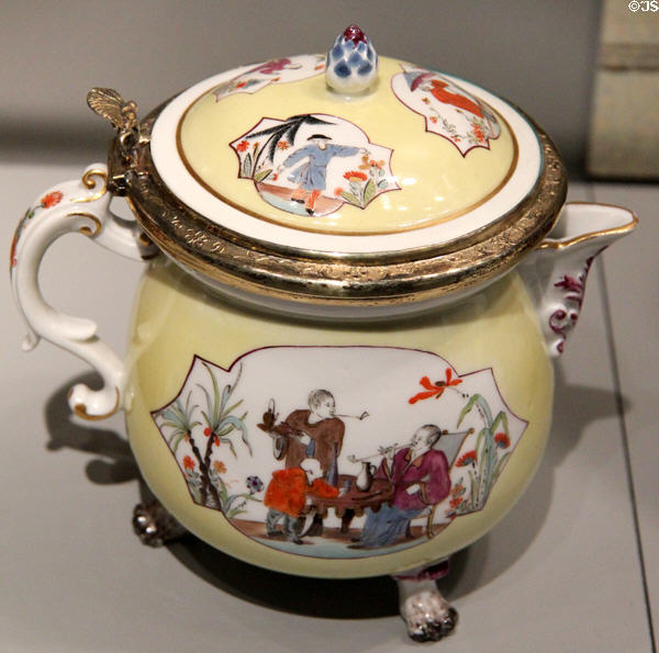 Meissen porcelain covered spouted Reintl on three feet decorated in yellow with imaginary Chinese scenes in white quatrefoils (c1740) with silver mounts from Augsburg at Gardiner Museum. Toronto, ON.