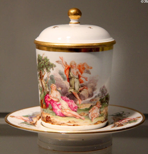 Porcelain covered chocolate cup with Baroque scene on trembleuse saucer (c1770-75) by Höchst of Frankfurt am Main at Gardiner Museum. Toronto, ON.