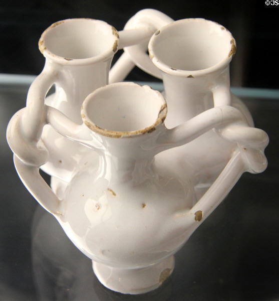 Fuddling cup of white English delftware (1630-60) from. London at Gardiner Museum. Toronto, ON.