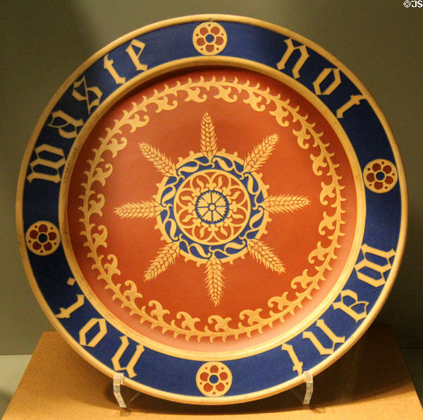 Stoneware bread dish inscribed 'Waste not - Want not' in Gothic Revival style (c1849-55) by A.W.N, Pugin for Minton of Stoke-on-Trent, England at Gardiner Museum. Toronto, ON.