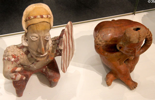 Ameca-Etzatlán style earthenware seated figures (300 BCE - 300 CE) 1st with shield & 2nd as hunchback from Jalisco, Mexico at Gardiner Museum. Toronto, ON.
