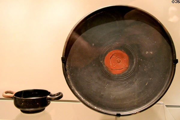 Roman Republic earthenware black-glazed cup (c300-275 BCE) & plate (c150-50 BCE) at Royal Ontario Museum. Toronto, ON.