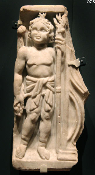 Roman marble funerary sculpture with cupid holding a torch (100-200 CE) at Royal Ontario Museum. Toronto, ON.