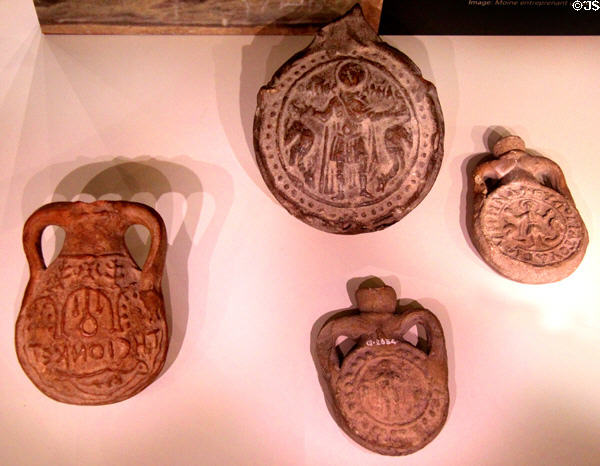 Earthenware Pilgrim flask shows arches of shrine in Palestine (500-600 CE) & 3 flasks to carry curative holy water from martyred St Menas shrine at Abu Mena, Egypt (550-700 CE) at Royal Ontario Museum. Toronto, ON.