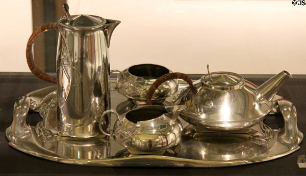 Tudric tea service in pewter with wicker handles (1903) by Archibald Knox & made for Liberty & Co by W.H. Haseler at Royal Ontario Museum. Toronto, ON.