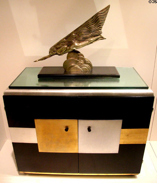 Art Deco cabinet (c1930) by Paul Theodore Frankl of New York City holding silvered-bronze & marble sculpture of woman in flight (1920s) by Maurice Guiraud-Rivière from France at Royal Ontario Museum. Toronto, ON.