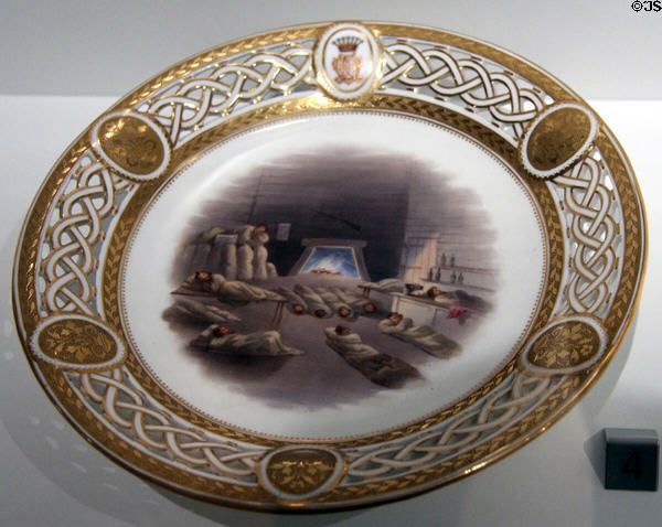 Porcelain plate with print of Way Side House at Midnight (c1867) by Minton of Longton, Staffordshire, England part of Lord Milton dessert service at Royal Ontario Museum. Toronto, ON.