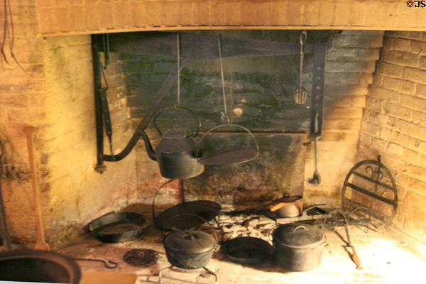 Grange building (1817) original cooking fireplace with antique cast iron implements inside Art Gallery of Ontario. Toronto, ON.