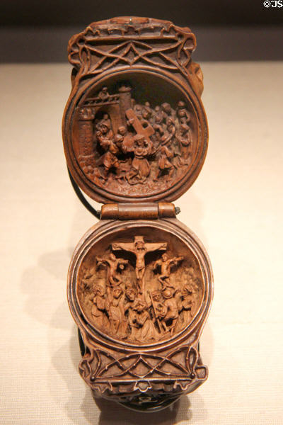 Small carved boxwood prayer bead with Christ carrying Cross above & crucifixion below at Art Gallery of Ontario. Toronto, ON.