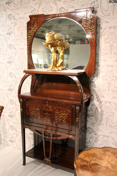 Art Nouveau cabinet (c1902) by Carlo Zen of Italy holding Loïe Fuller Table Lamp in form of dancing woman (c1898) by Raoul Larche of Paris at Montreal Museum of Fine Arts. Montreal, QC.