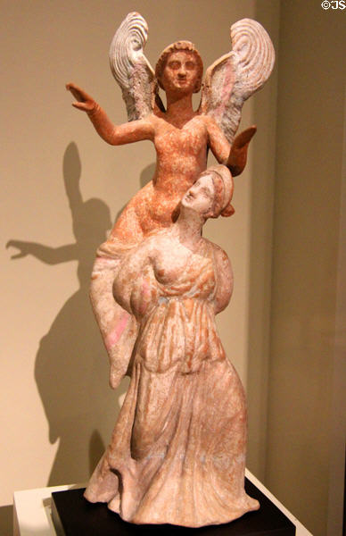 Terracotta group of ephedrismos: young woman with Eros on her shoulder (1st half of 2ndC BCE) possibly from Taranto, Italy at Montreal Museum of Fine Arts. Montreal, QC.