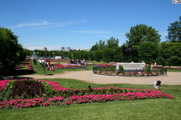 Gardens before Saskatchewan Legislature with downtown Regina across lake. Regina, SK.