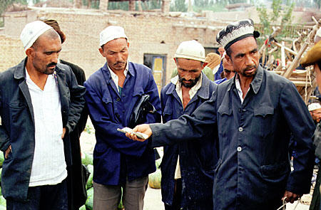 Men at the Sunday market in Kashgar. China.