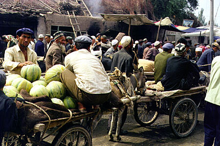 People and their carts full of goods at the Sunday market in Kashgar. China.