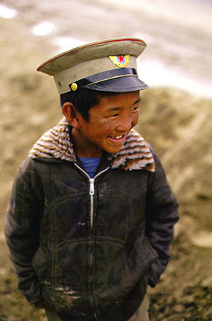 Child wearing a Chinese Captain's hat in Lhasa, Tibet. China.